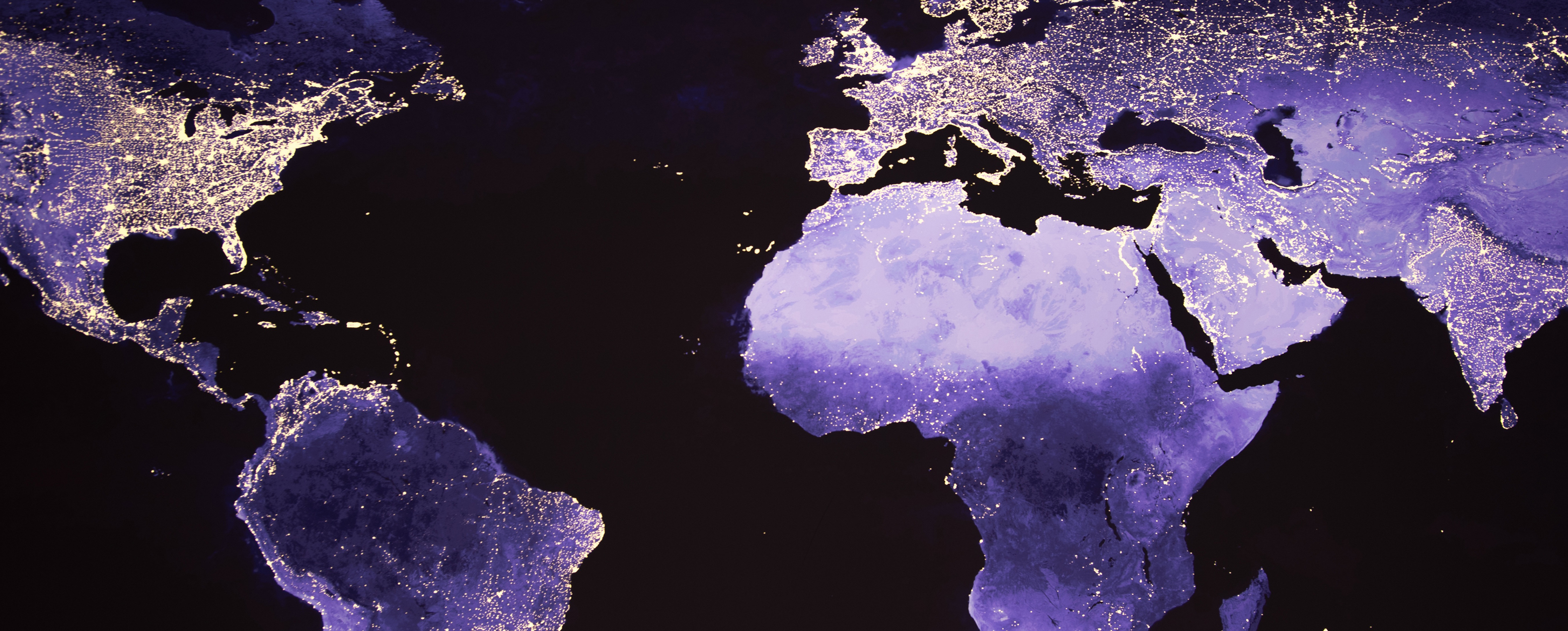 World map standing out in purple with glowing areas of land